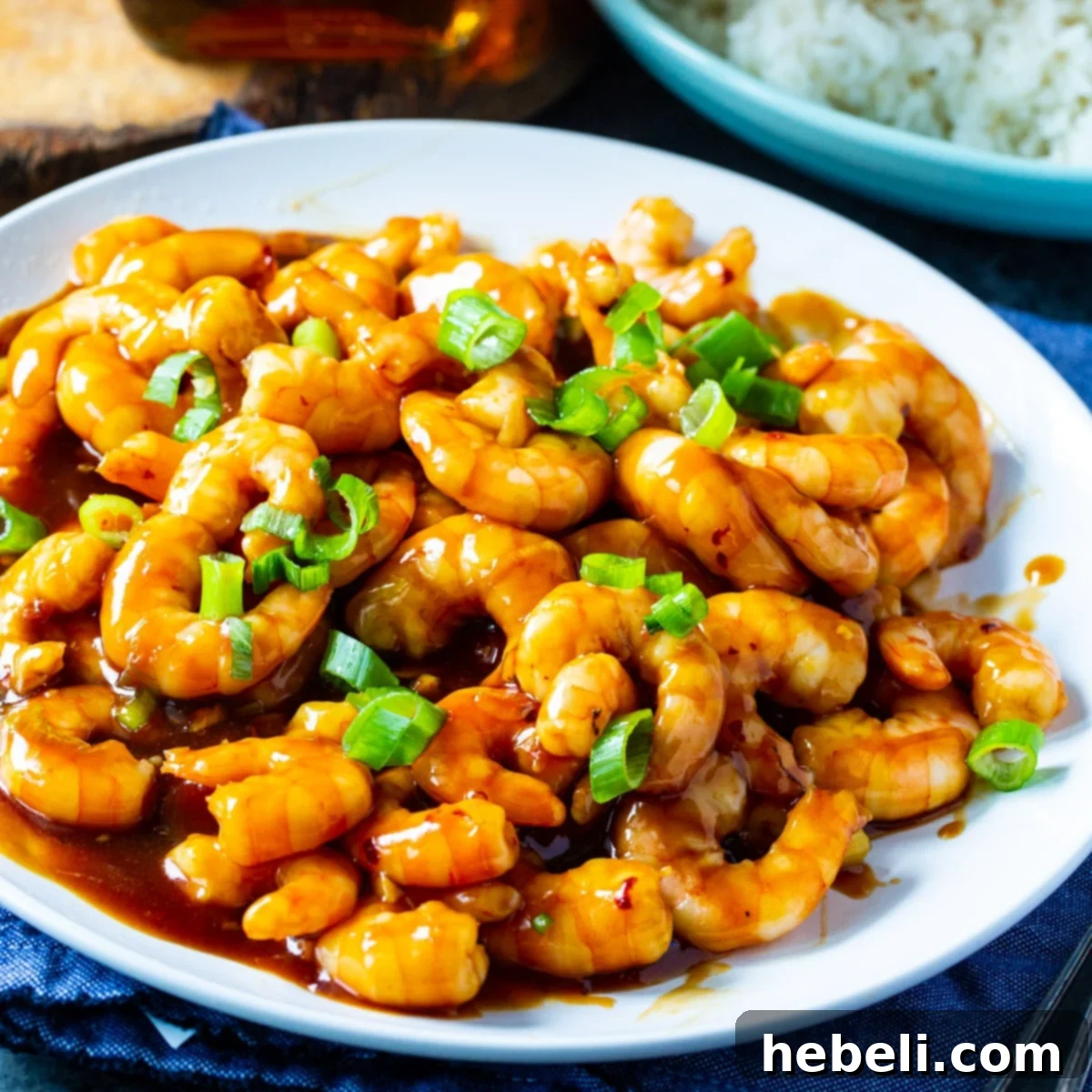 Bourbon Glazed Shrimp 2 Bourbon Shrimp topped with sliced green onions on a plate, ready to be served.