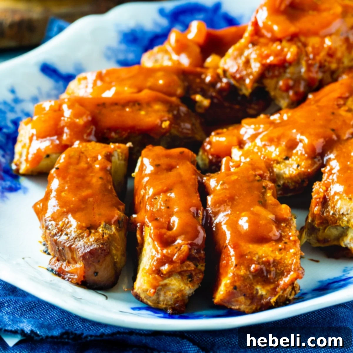 Delicious BBQ Country Ribs on a serving platter, glazed with sweet and tangy sauce.