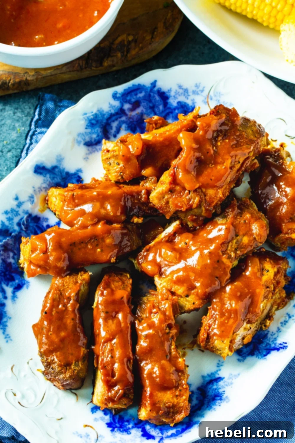 Close-up of individual BBQ Country Ribs coated in sweet and savory sauce on a serving platter.