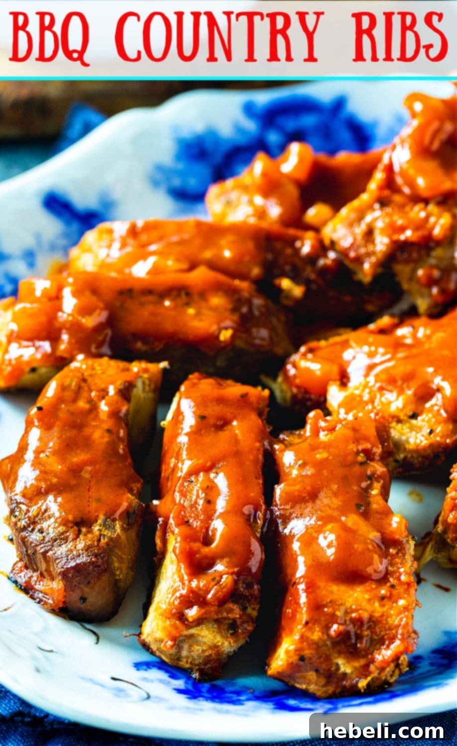 Close-up view of succulent BBQ Country Ribs, glistening with sauce, on a white plate.