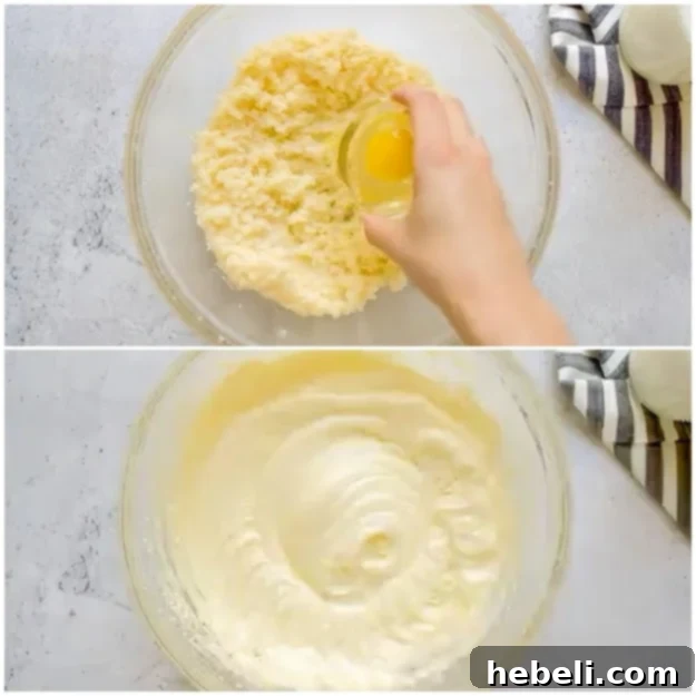 Adding eggs one by one into the creamed butter and sugar mixture.