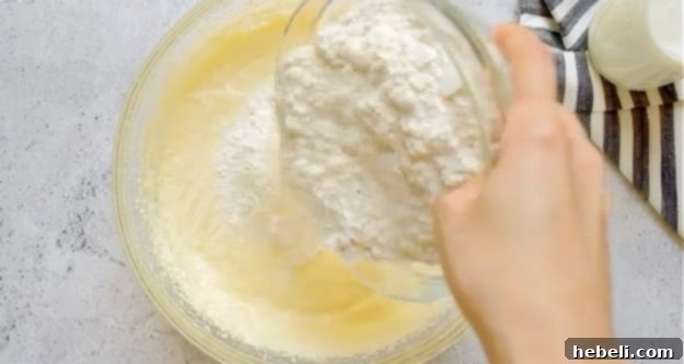 Gently mixing flour into the buttermilk cake batter.