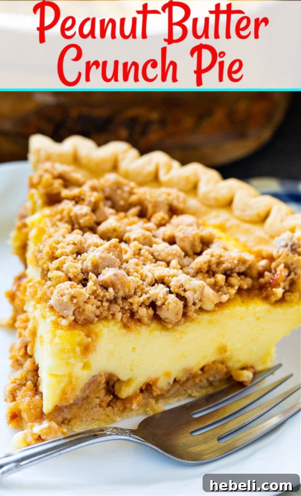 Full Peanut Butter Crunch Pie with a decorative crumb topping and a rustic background.