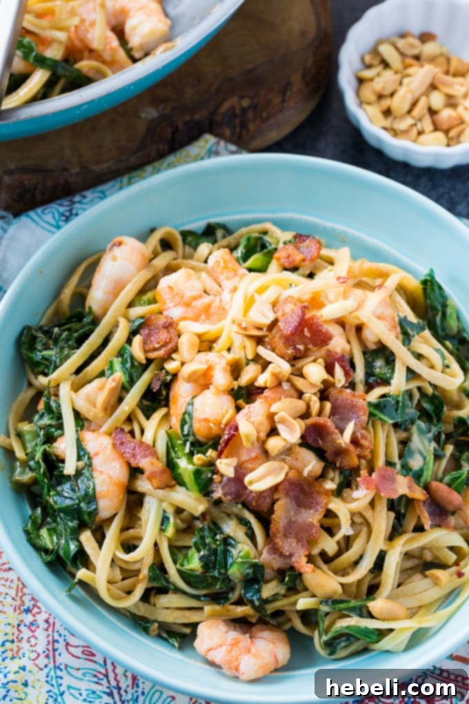 Close-up of Southern Peanut Noodles with crispy bacon and wilted collard greens