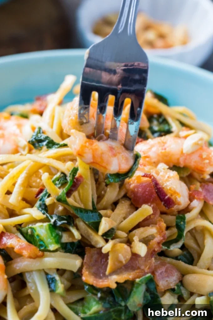 Plated Southern Peanut Noodles with Shrimp, garnished with bacon and peanuts and fresh cilantro