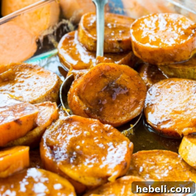 Classic Southern Candied Sweet Potatoes 2 Delicious Southern Candied Sweet Potatoes in a baking dish, glistening with a buttery, sweet glaze, ready to serve for a festive meal.