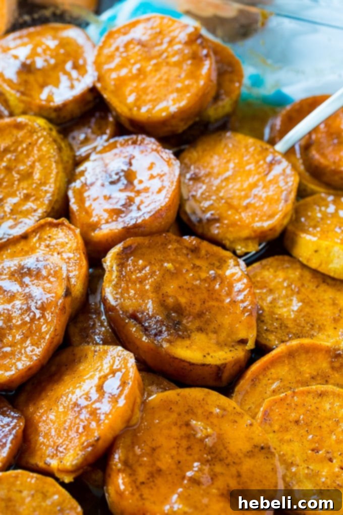 Classic Southern Candied Sweet Potatoes 4 Close-up of baked Southern Candied Sweet Potatoes, glistening with a rich, golden-brown caramelized glaze and tender texture.
