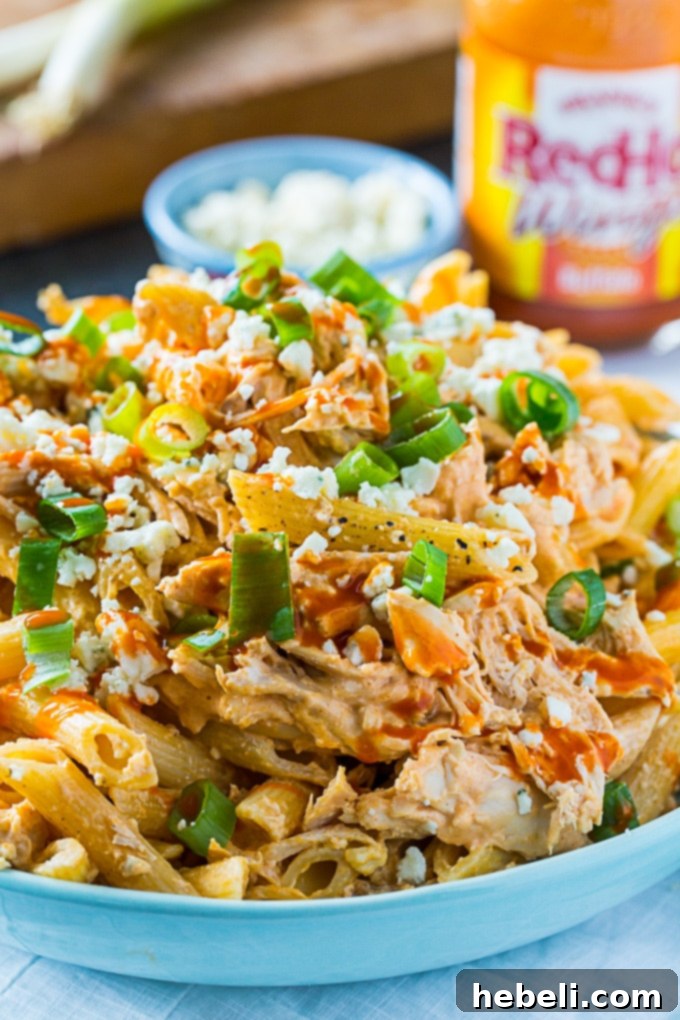 Buffalo Chicken Pasta - Overhead shot of the finished dish with serving utensils