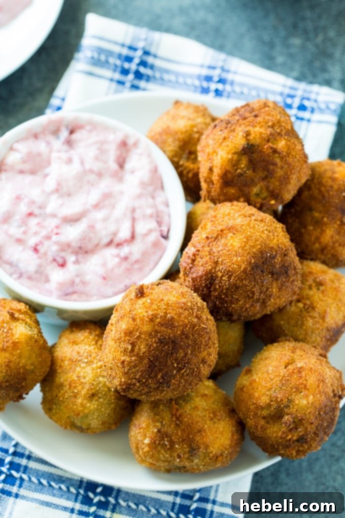Deep-Fried Stuffing balls achieving a perfect golden crisp in hot oil within a Dutch oven.