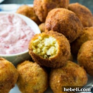 Deep-Fried Stuffing balls on a plate with cranberry sauce
