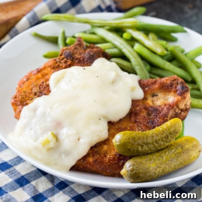 Tangy Pickle Gravy Pork Chops 2 Fried Pork Chops with Pickle Juice Gravy, crispy and golden