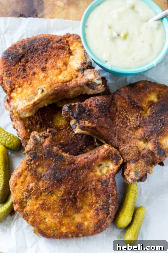 Tangy Pickle Gravy Pork Chops 3 Fried Pork Chops with Pickle Juice Gravy served with mashed potatoes and green beans
