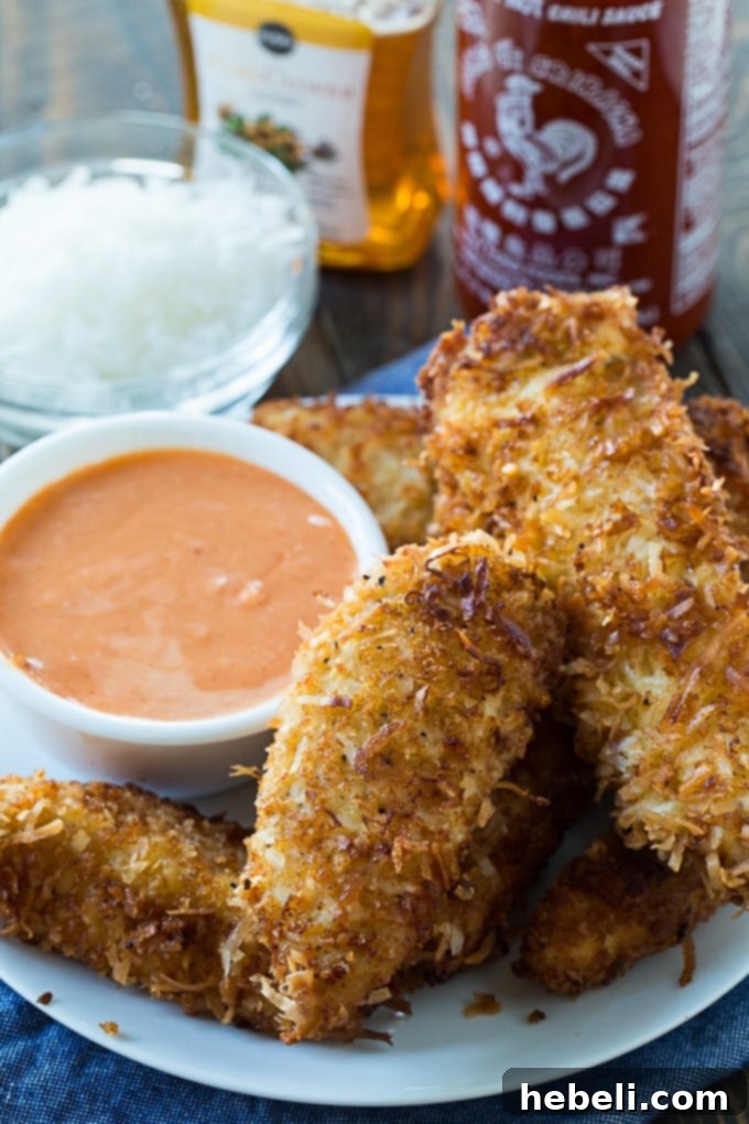 Island Coconut Chicken Strips 3 Closeup of Coconut Chicken Fingers with rich honey sriracha sauce, highlighting the texture