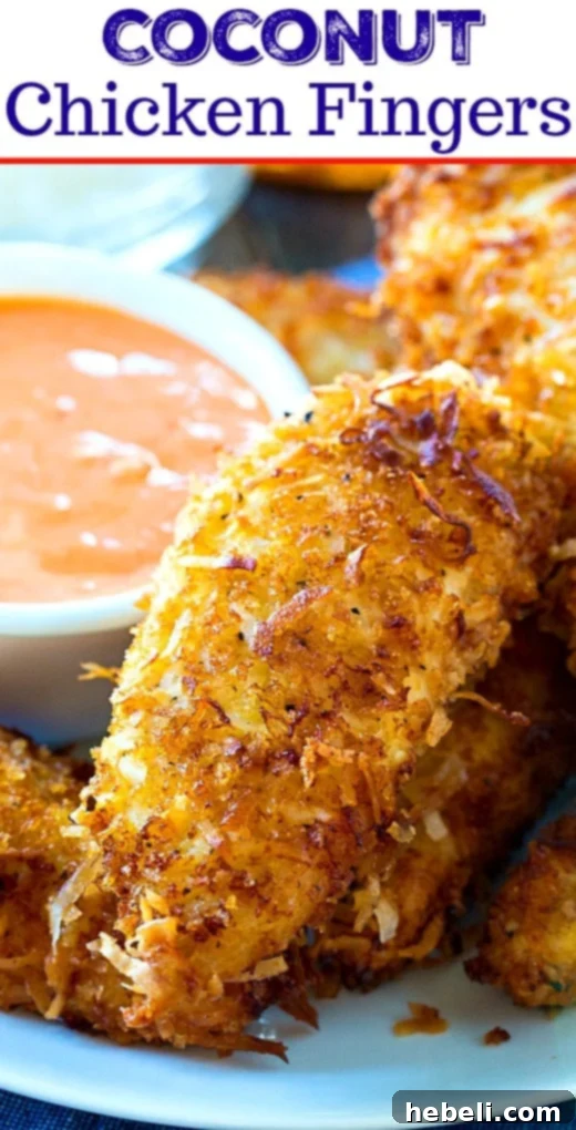 Island Coconut Chicken Strips 6 Close up of a single Coconut Chicken Finger with visible crispy coating and coconut flakes