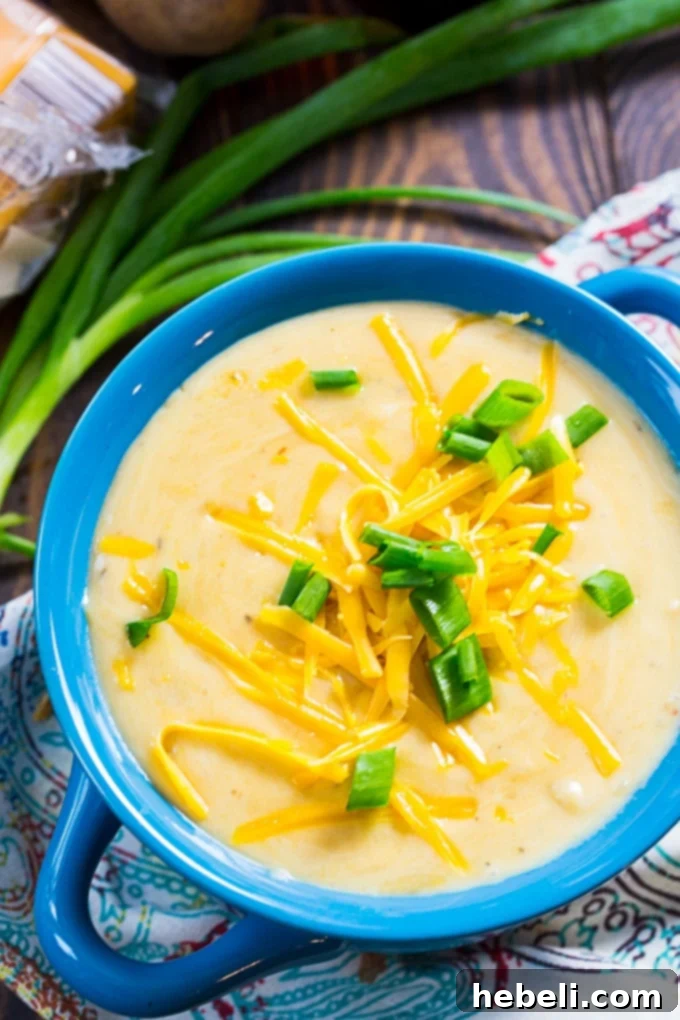 Velvety Slow Cooker Beer Cheese Potato Soup 4 Slow cooker filled with ingredients for Potato Beer Cheese Soup simmering