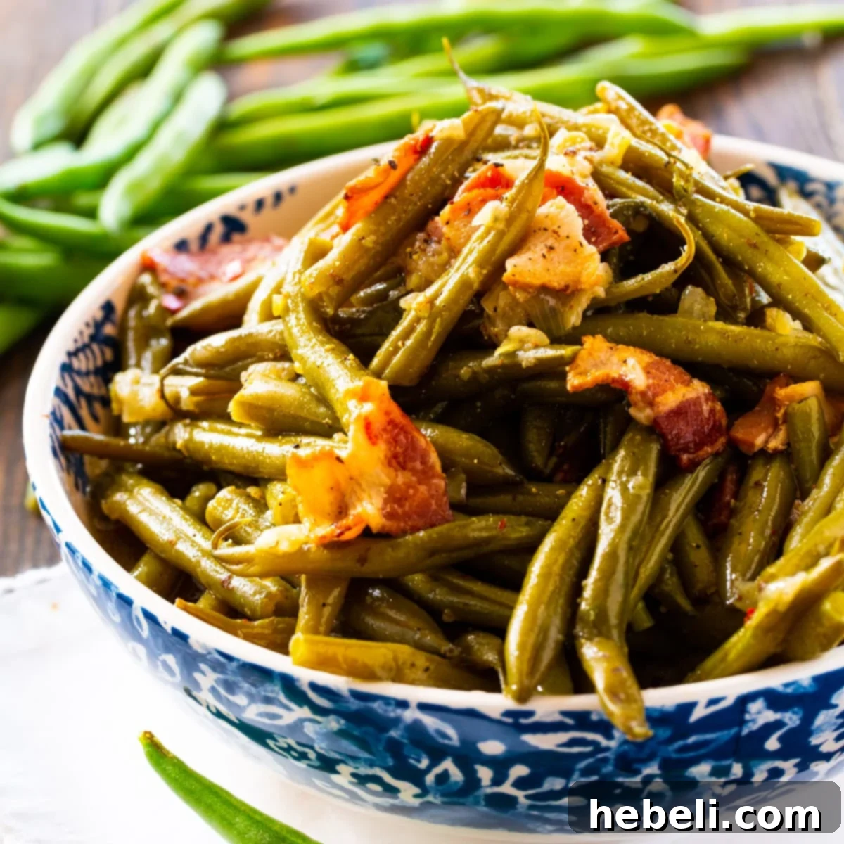 A vibrant bowl of Instant Pot Southern Green Beans, garnished with crispy bacon bits, ready to be served as a delicious side dish.