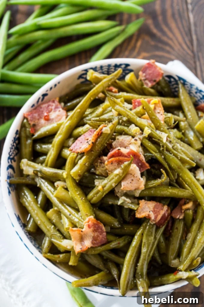 Close-up view of southern green beans, cooked to perfection in a pressure cooker, infused with rich, savory flavors.