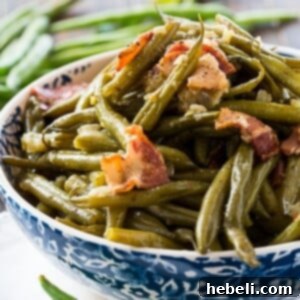 Beautifully plated Instant Pot Southern Green Beans, garnished with fresh herbs and crispy bacon, ready to be enjoyed.