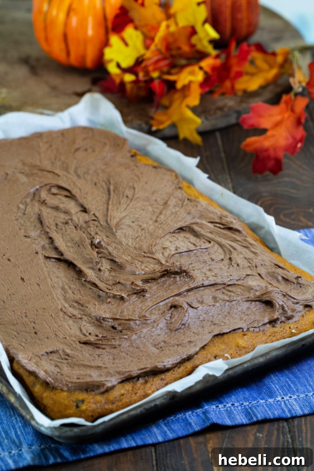 A magnificent full pumpkin sheet cake, generously covered with smooth Nutella cream cheese frosting, waiting to be enjoyed.