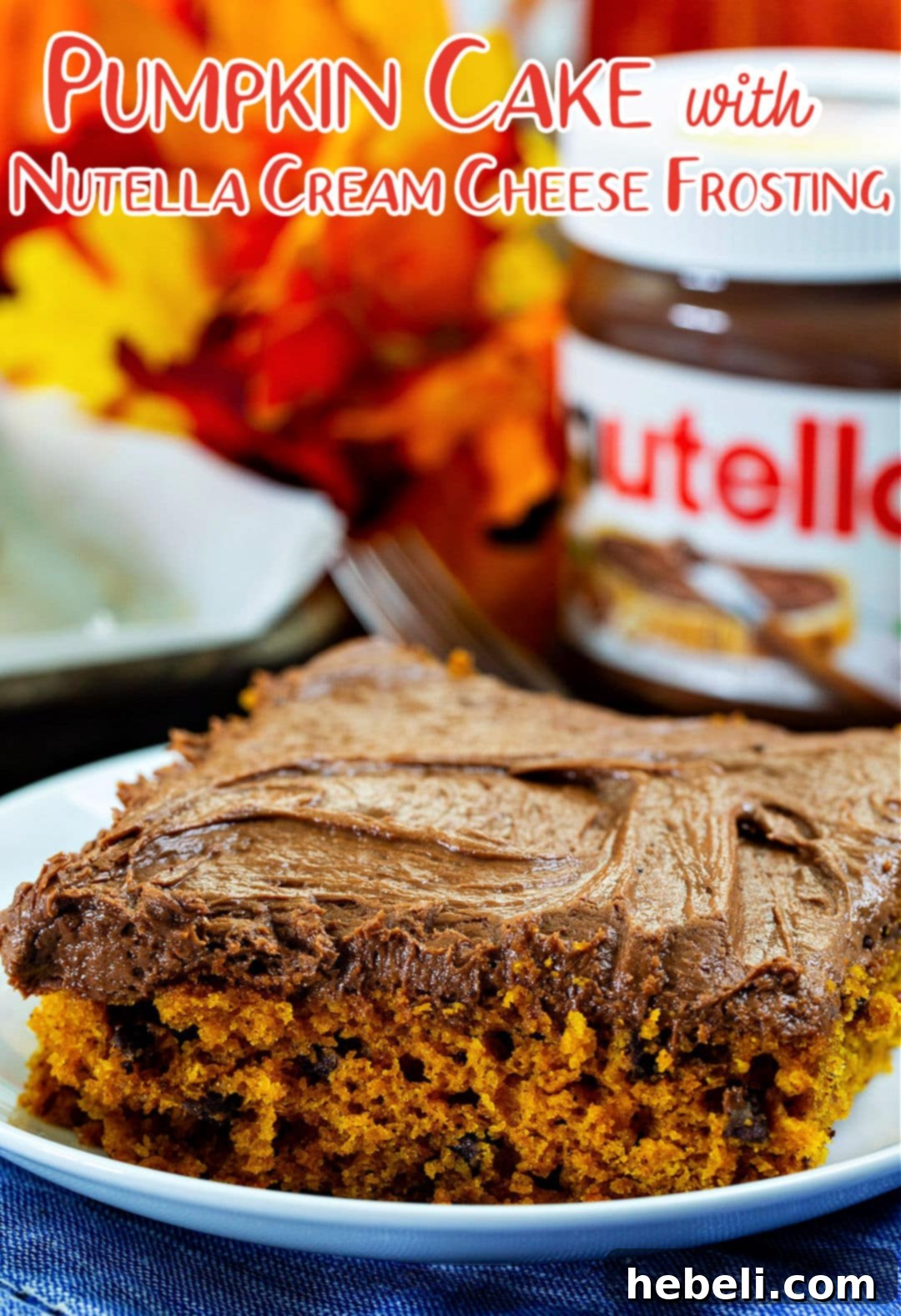 A close-up of a single slice of Pumpkin Sheet Cake with Nutella Cream Cheese Frosting on a small white plate, with a jar of Nutella subtly blurred in the background, emphasizing the key frosting ingredient.