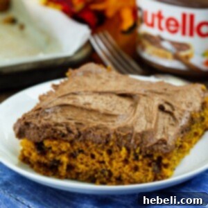 Completed Pumpkin Sheet Cake with Nutella Cream Cheese Frosting, ready to be cut into generous squares.