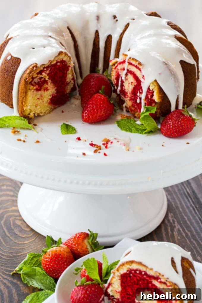 Decadent Red Velvet Marble Bundt 3 Close-up of a slice of Red Velvet Marble Bundt Cake showing the intricate swirl and a delicate glaze drizzle