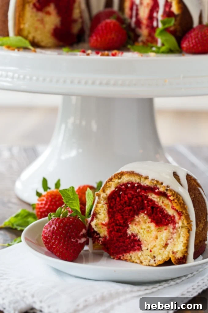 Decadent Red Velvet Marble Bundt 4 Red Velvet Marble Bundt Cake drizzled with a rich vanilla glaze, presented on a white cake stand