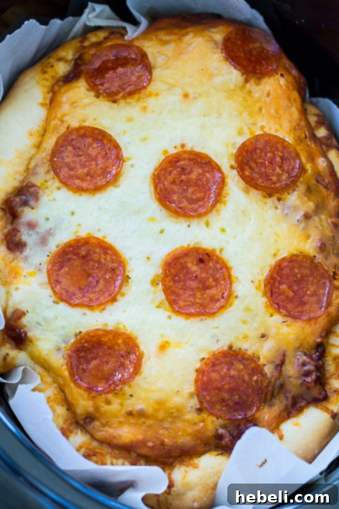 Effortless Slow Cooker Deep Dish Pizza 3 Close-up of Slow Cooker Deep Dish Pizza showing layers of cheese, sauce, and toppings before cooking