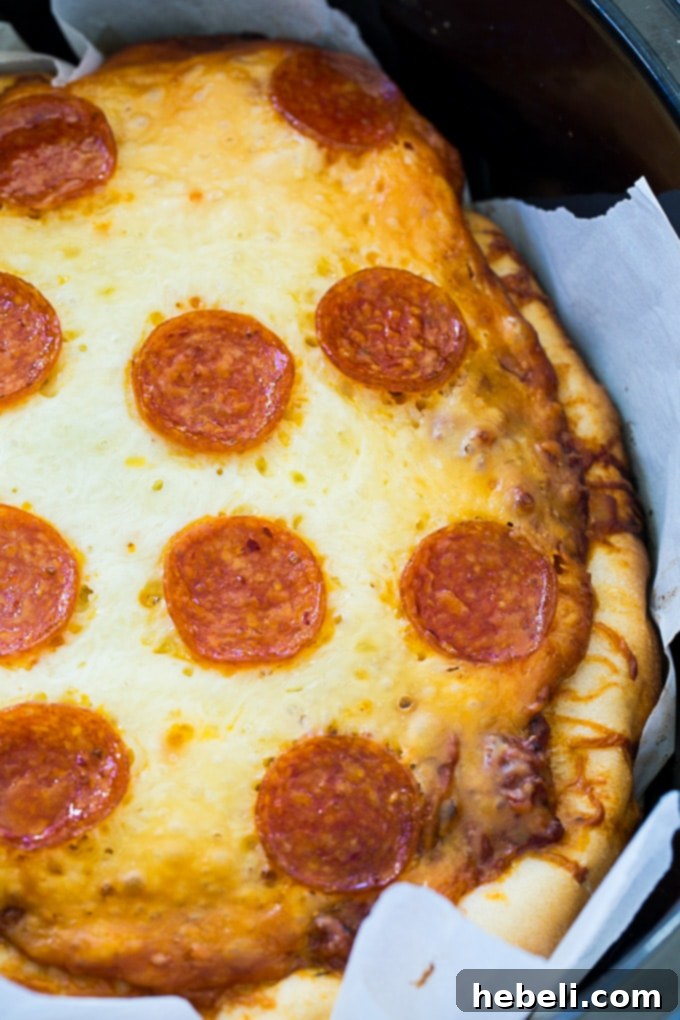 Effortless Slow Cooker Deep Dish Pizza 4 Parchment paper lining the slow cooker for easy removal of deep dish pizza