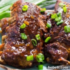 Close-up of succulent slow cooker Hawaiian ribs with a glossy pineapple teriyaki glaze.