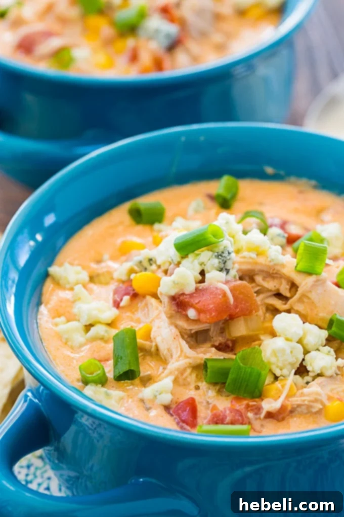 Another enticing angle of Crock Pot Buffalo Chicken Chili in a bowl, highlighting its rich texture and vibrant toppings.