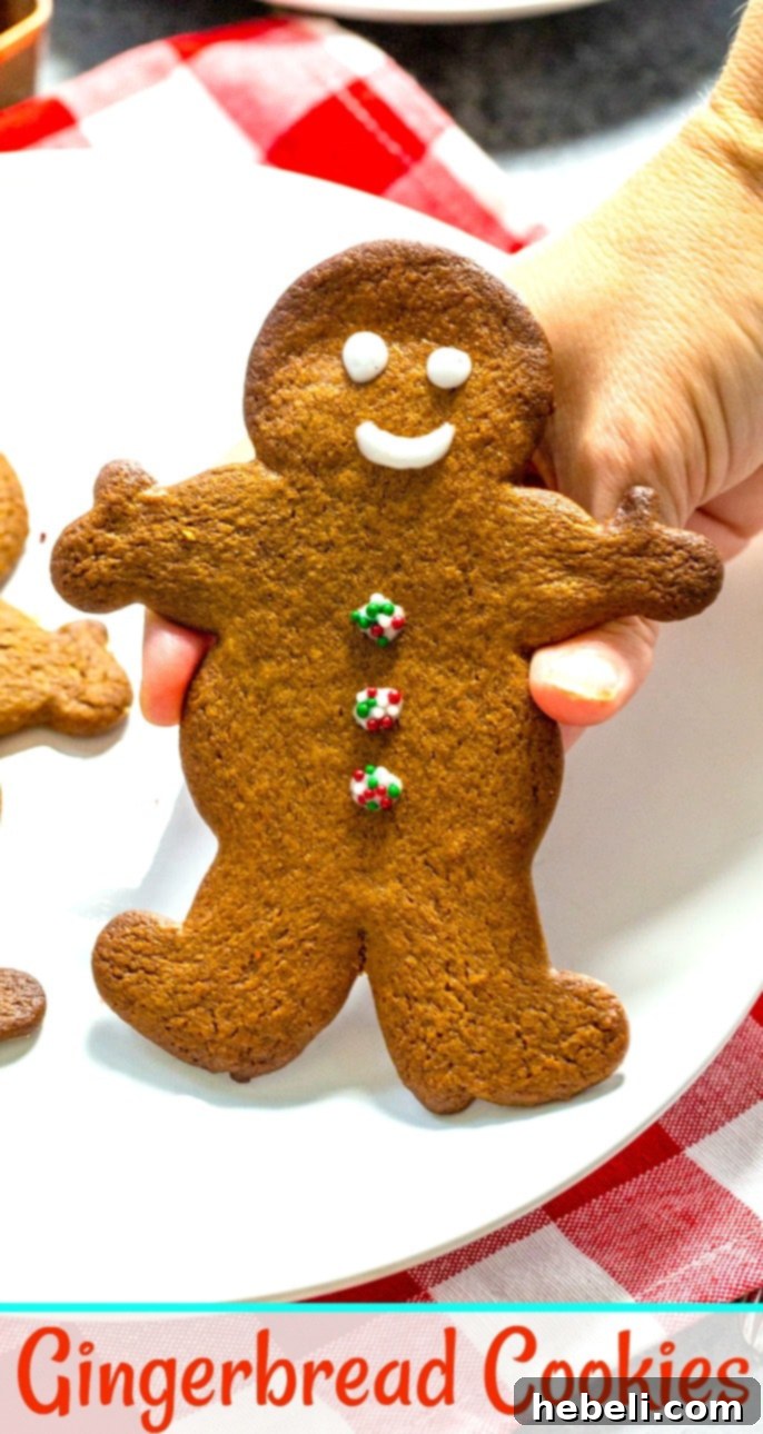 Festive Gingerbread Delights 6 A hand carefully holding a freshly baked and decorated gingerbread cookie, showcasing its perfect texture and festive design.