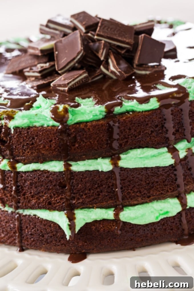 Beautifully stacked Andes Layer Cake with green peppermint frosting and chocolate ganache