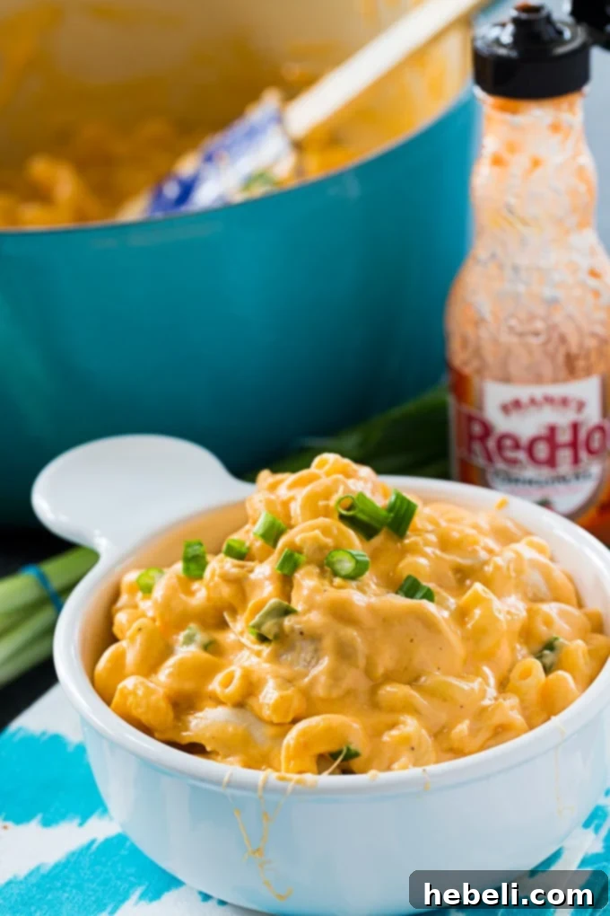Close up of Buffalo Chicken Mac and Cheese in a bowl, showing the creamy texture and shredded chicken. Perfect for spicy mac and cheese lovers.
