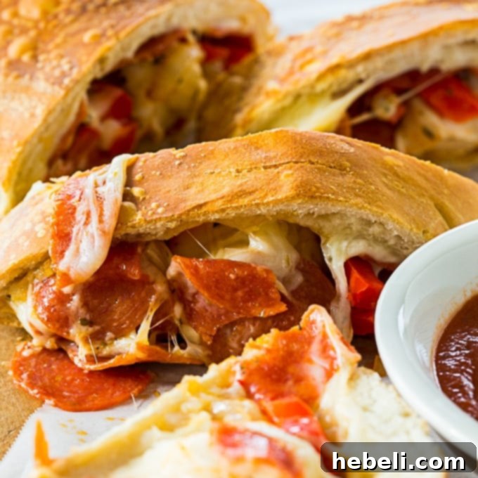 Easy Air Fryer Pepperoni and Peppers Stromboli 2 Crispy Air Fryer Pepperoni and Peppers Stromboli, golden brown and ready to slice