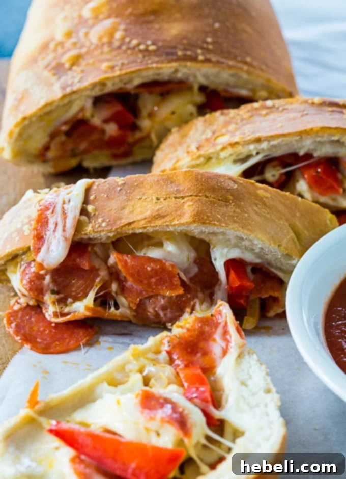 Easy Air Fryer Pepperoni and Peppers Stromboli 4 Sliced Air Fryer Pepperoni and Peppers Stromboli ready for serving