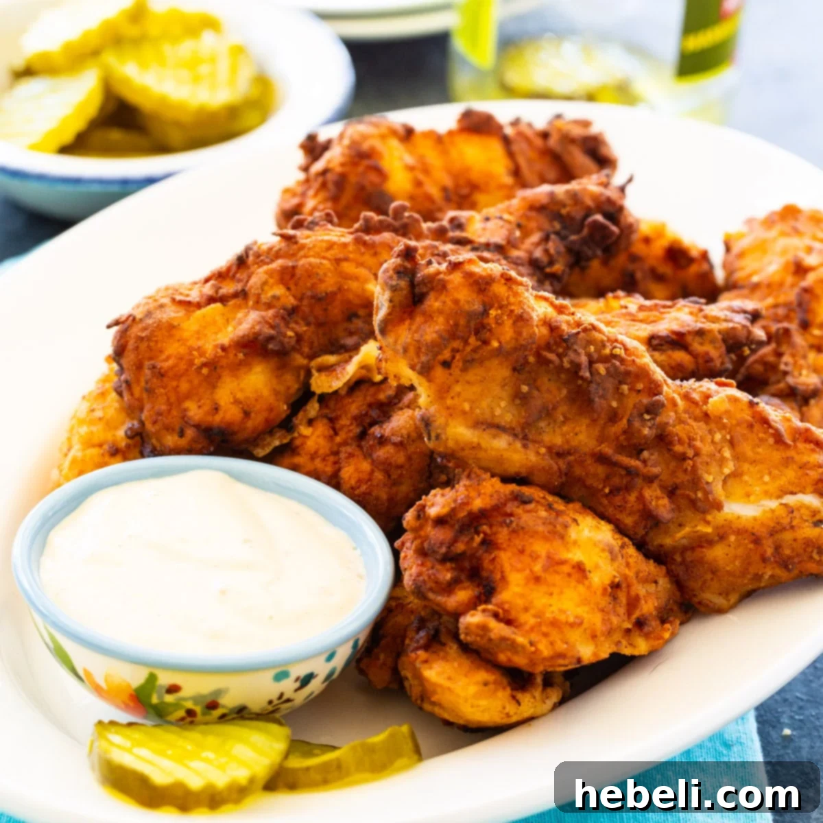 Dill Pickle Chicken Tenders 2 Pickle-Brined Chicken Tenders on plate with small bowl of dipping sauce.