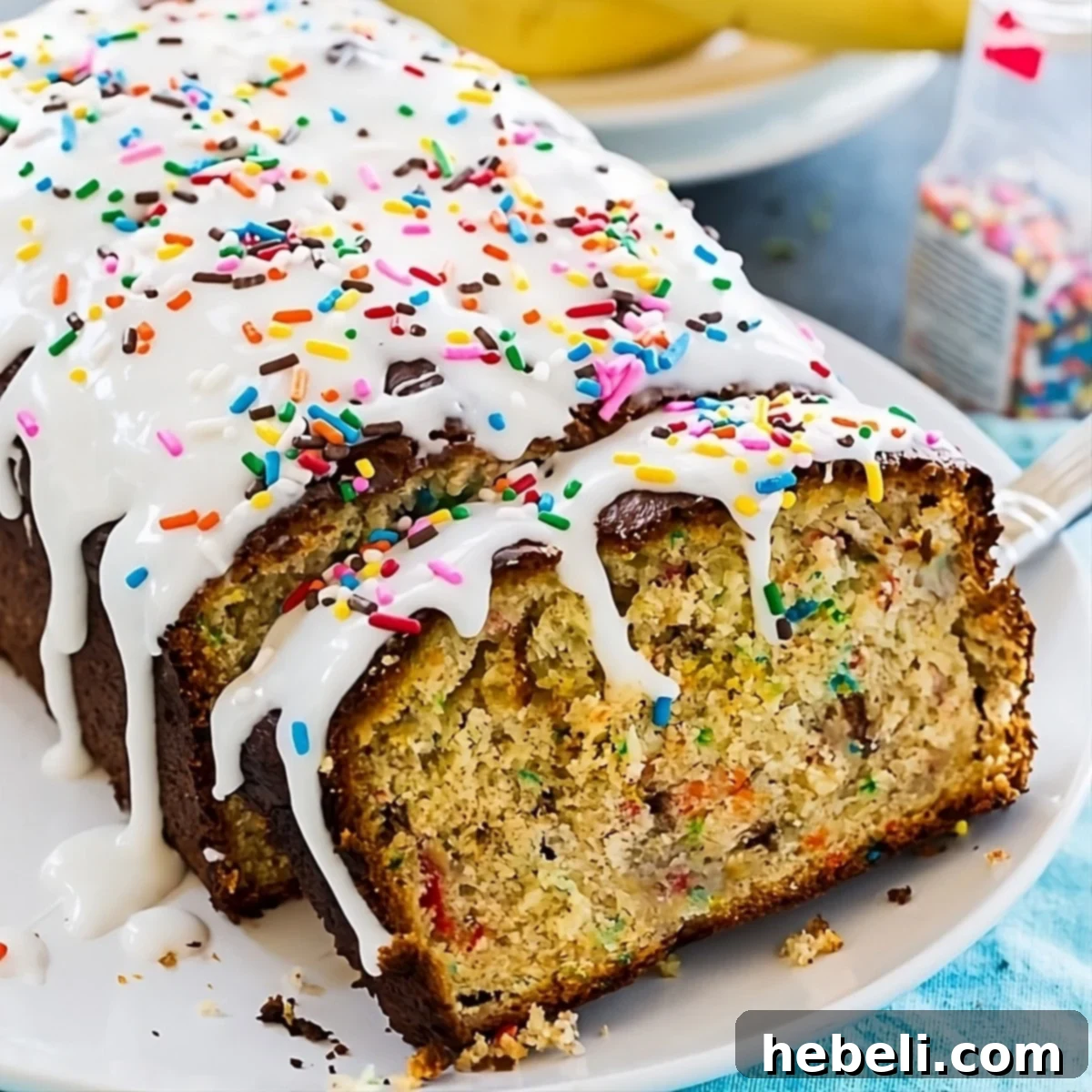 A slice of Funfetti Banana Bread showcasing its colorful sprinkles and sweet glaze, ready to be enjoyed.