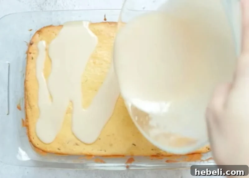 Glaze being poured over a hot Honey Bun Cake.
