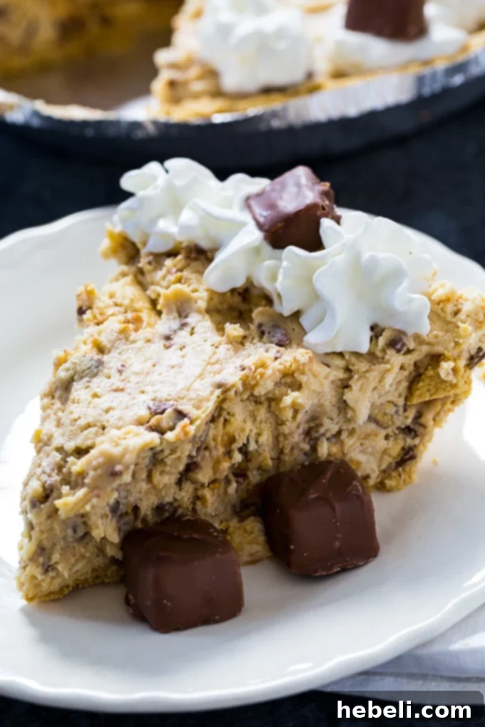 Effortless Snickers Dream Pie 3 Close-up of creamy No-Bake Snickers Pie filling with chopped Snickers