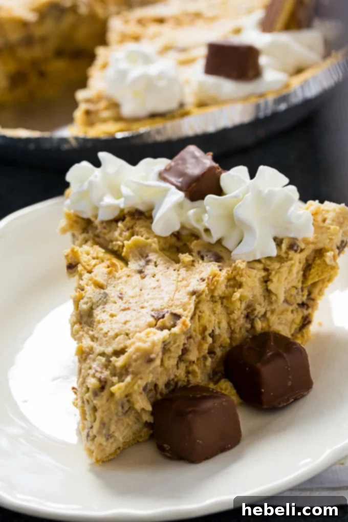 Effortless Snickers Dream Pie 4 Slice of No-Bake Snickers Pie with whipped cream and mini Snickers