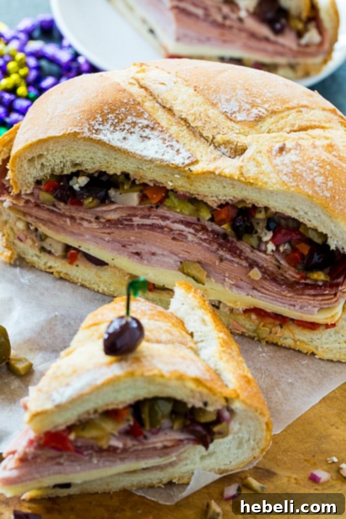 A close-up shot of a prepared Muffaletta Sandwich, showing the layers of ingredients and the texture of the bread.
