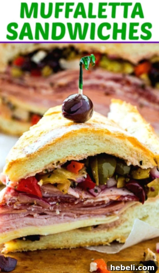 Close up of a Muffaletta sandwich cut into quarters, showing the rich fillings.