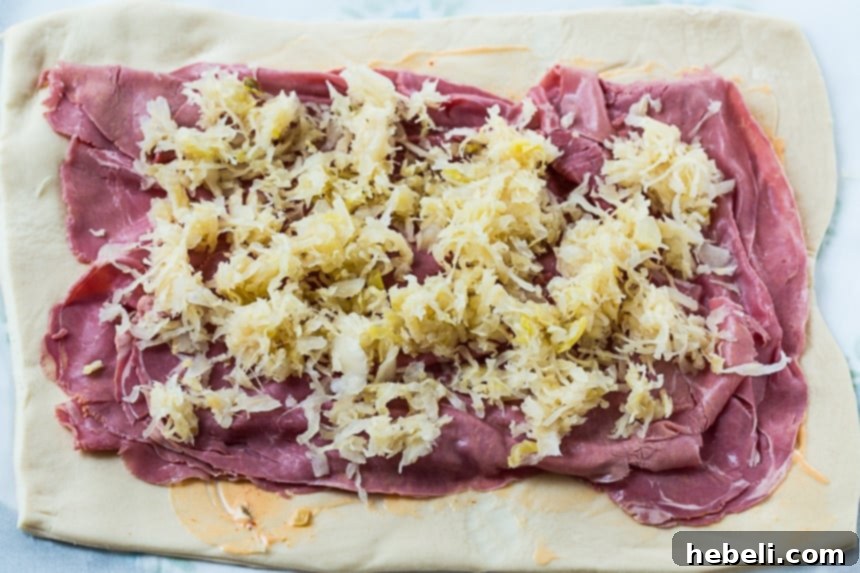 Crispy Air Fryer Reuben Stromboli 4 Pizza dough spread with Thousand Island dressing, corned beef, and sauerkraut