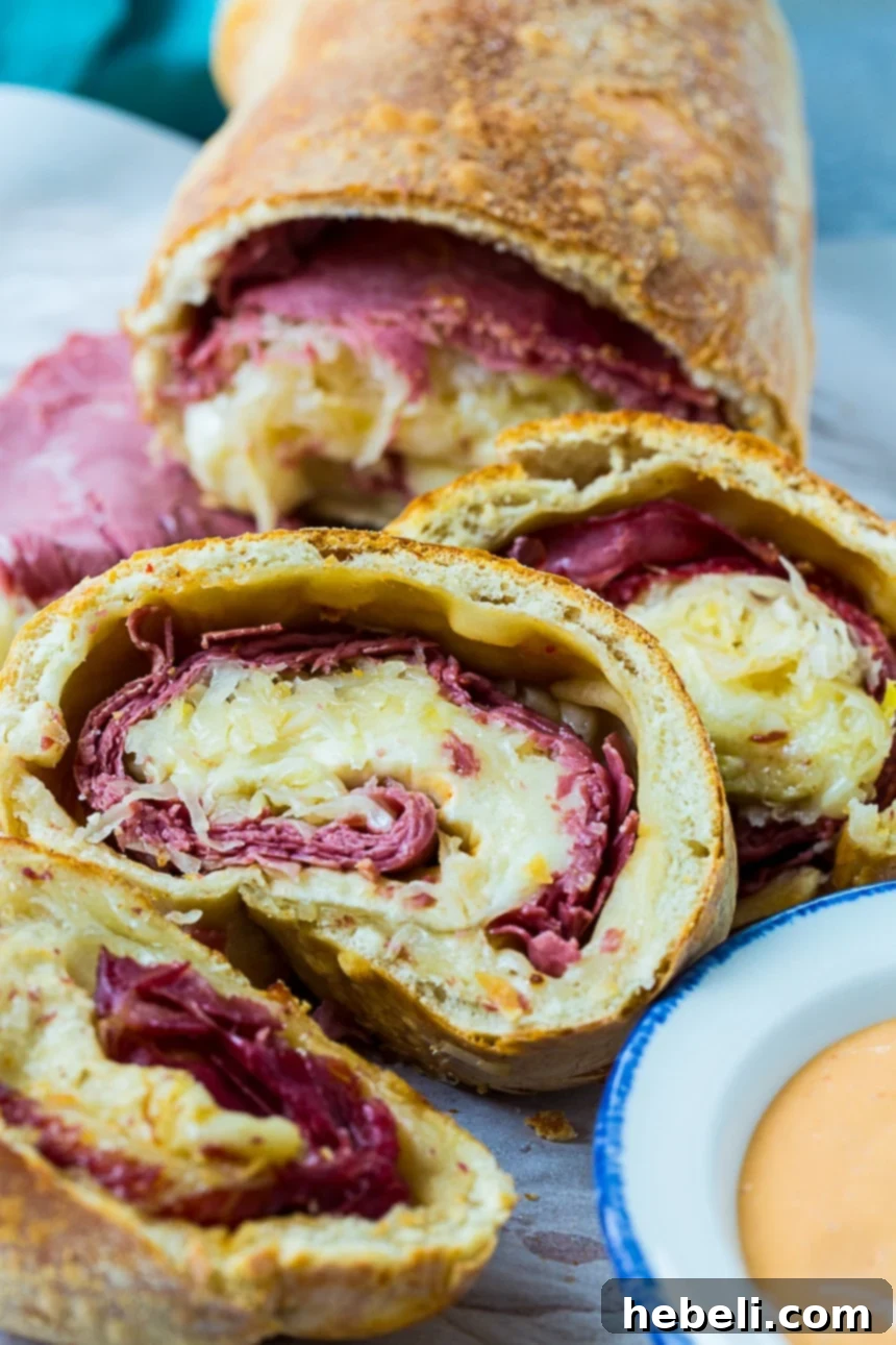 Crispy Air Fryer Reuben Stromboli 5 Air Fryer Reuben Stromboli cut into slices with Thousand Island dressing for dipping