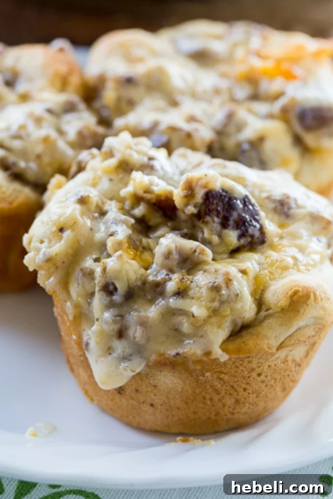 Sausage Gravy Stuffed Biscuit Cups 9 Sausage Gravy Biscuit Cups garnished with fresh parsley, highlighting their savory appeal