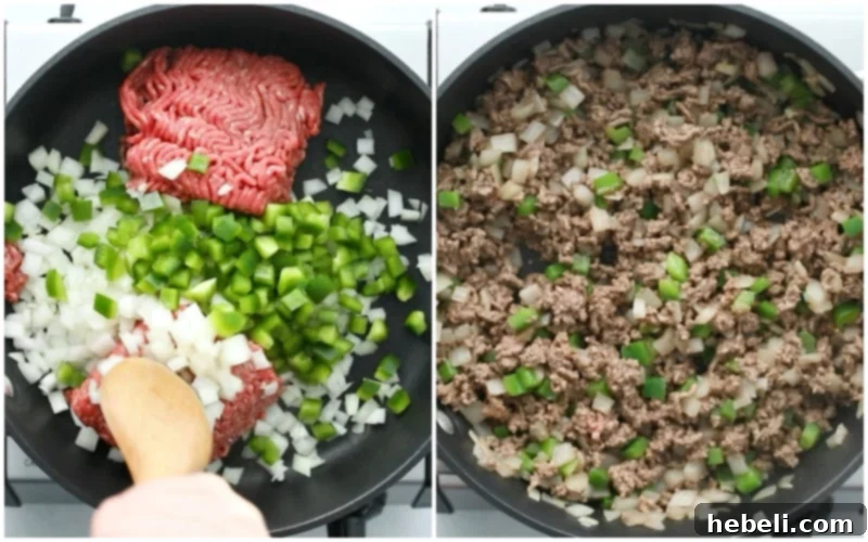 Ground beef mixture cooking in a skillet with onions and bell peppers, browning evenly.
