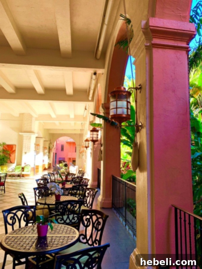 Guests enjoying drinks at the vibrant oceanfront Mai Tai Bar at The Royal Hawaiian, with the ocean in the background
