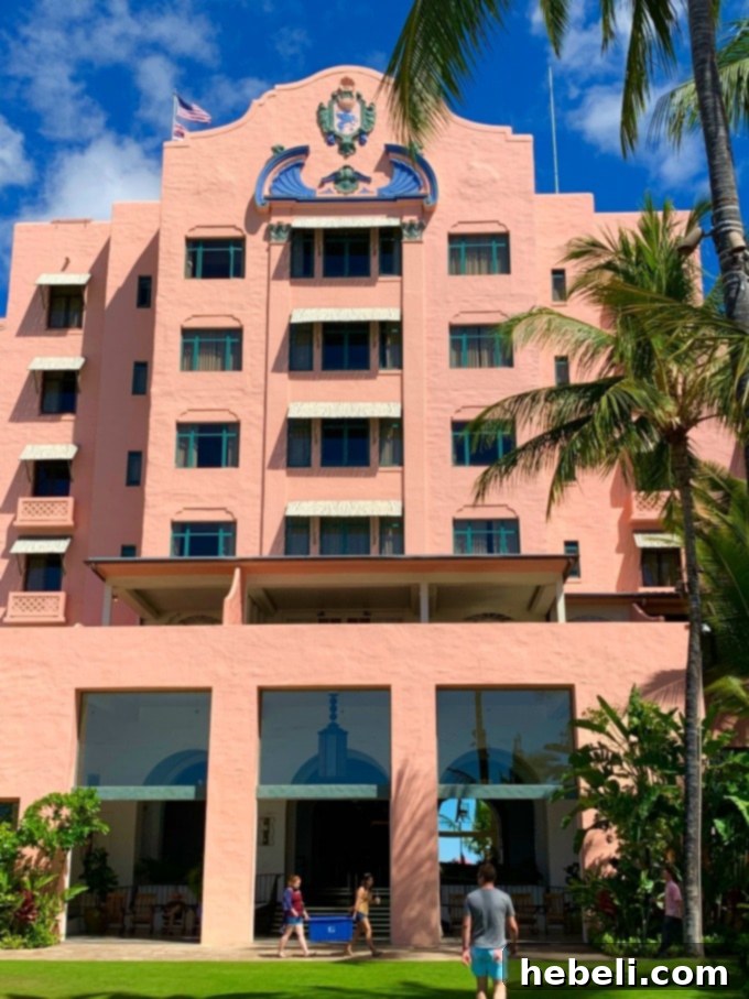 Lush tropical gardens and pathways within The Royal Hawaiian property, offering a tranquil escape amidst vibrant greenery