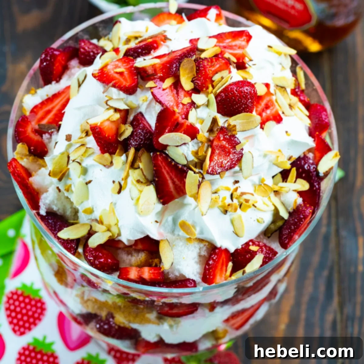 Velvet Amaretto Strawberry Trifle 2 Stunning Strawberry Amaretto Trifle topped with toasted slivered almonds, showcasing its beautiful layers in a clear glass bowl.